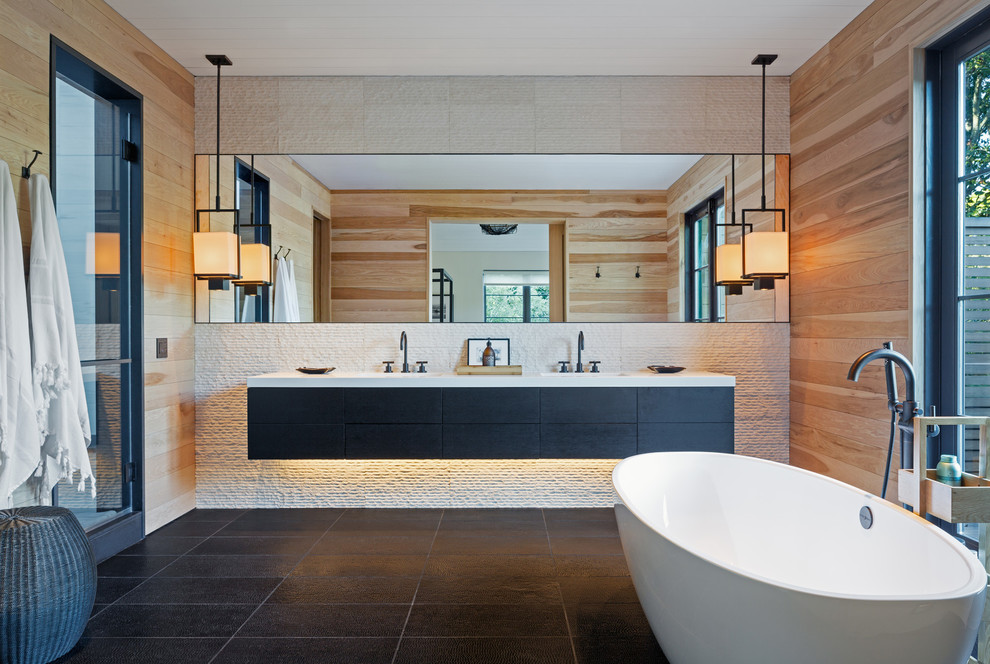 This is an example of a contemporary bathroom in New York with a freestanding tub and multi-coloured tile.