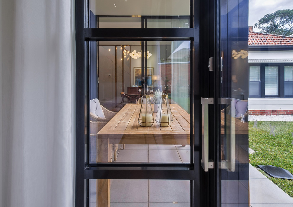 This is an example of a mid-sized contemporary backyard patio in Melbourne with concrete pavers.