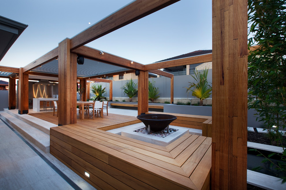 Contemporary patio in Perth with a fire feature, concrete pavers and a pergola.