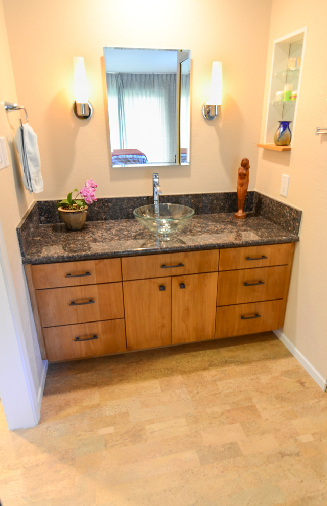 This is an example of a mid-sized traditional 3/4 bathroom in Tampa with a vessel sink, flat-panel cabinets, dark wood cabinets, granite benchtops, an alcove shower, a one-piece toilet, beige tile, porcelain tile, beige walls and cork floors.