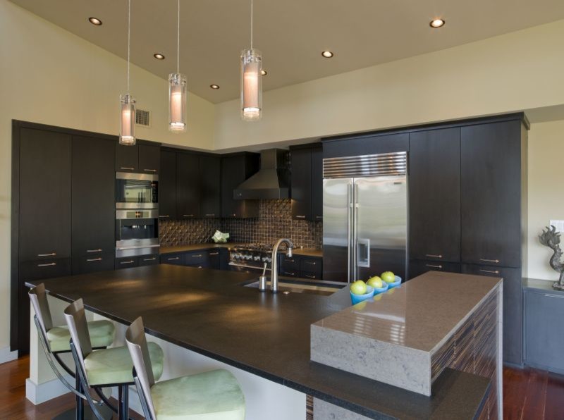 This is an example of a large contemporary l-shaped kitchen in Austin with black cabinets and with island.