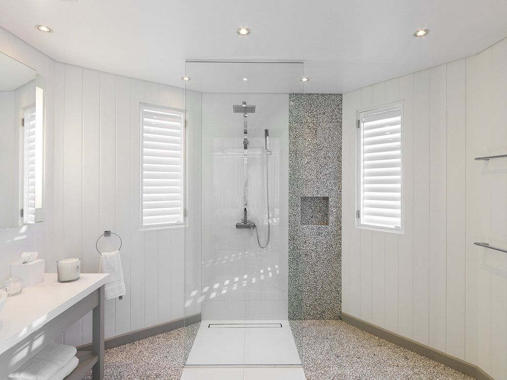 Large contemporary master bathroom in Other with a vessel sink, open cabinets, white cabinets, granite benchtops, a freestanding tub, an open shower, pebble tile, white walls and pebble tile floors.