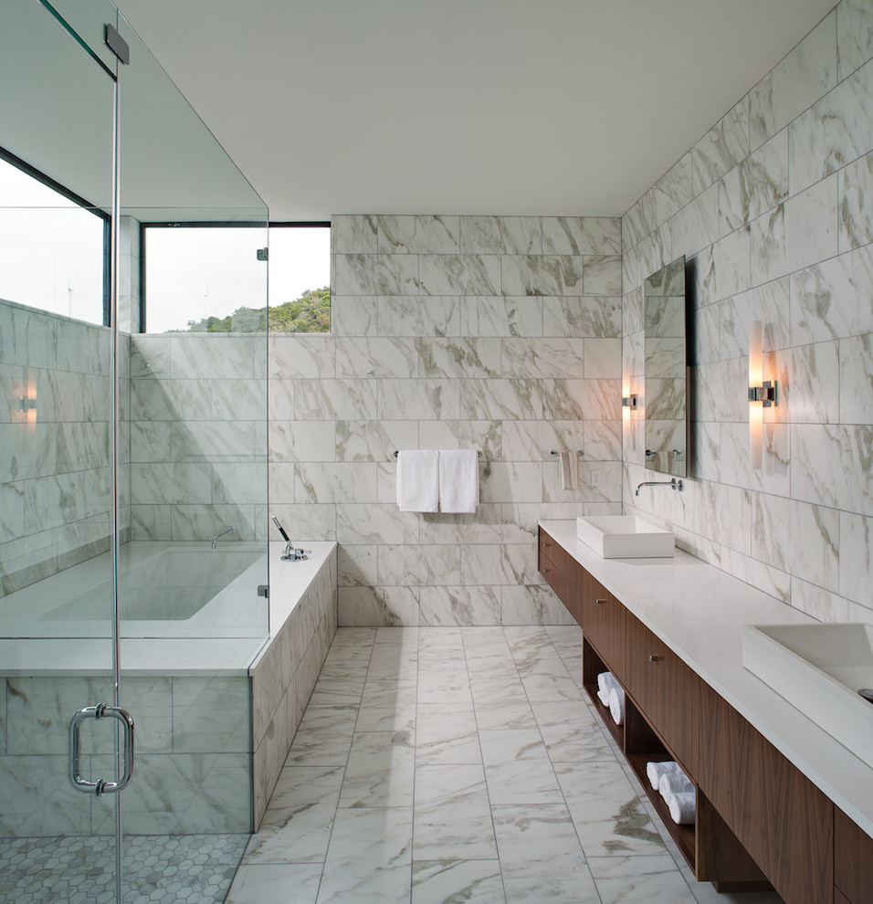 Design ideas for a contemporary bathroom in Austin with a vessel sink, flat-panel cabinets, dark wood cabinets, an undermount tub, a corner shower and white tile.