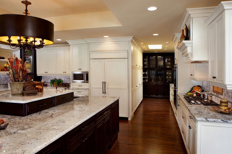 Design ideas for a large transitional eat-in kitchen in Orlando with flat-panel cabinets, white cabinets, granite benchtops, panelled appliances, dark hardwood floors and with island.