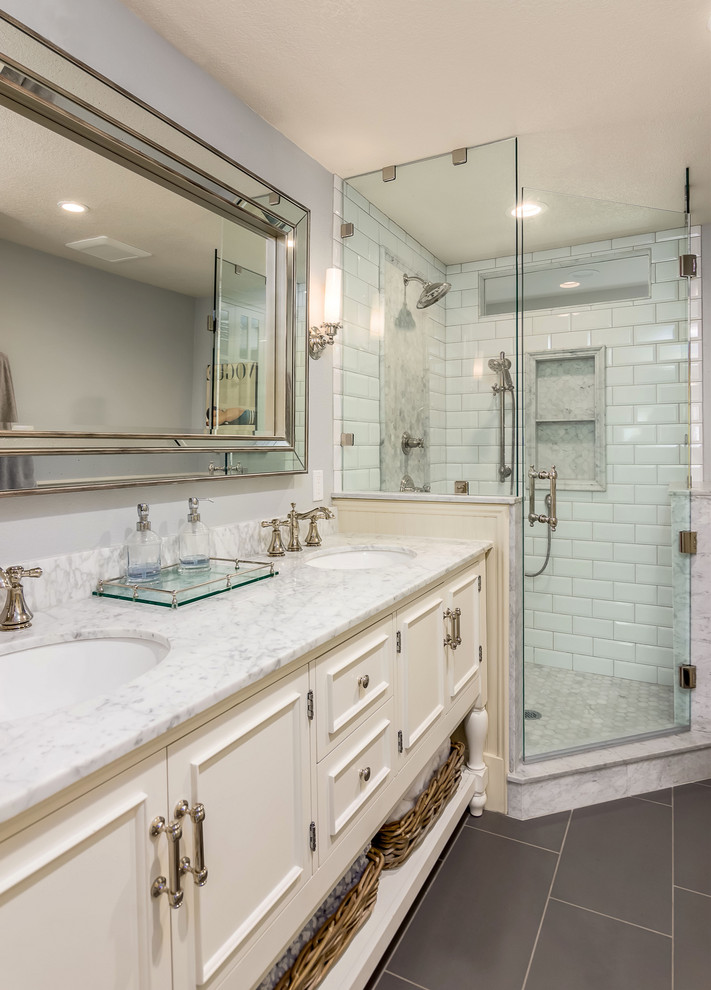 Inspiration for an expansive country master bathroom in Portland with white cabinets, raised-panel cabinets, a corner shower, a two-piece toilet, white tile, porcelain tile, grey walls, porcelain floors, an undermount sink, marble benchtops, grey floor, a hinged shower door, white benchtops, a double vanity and a freestanding vanity.