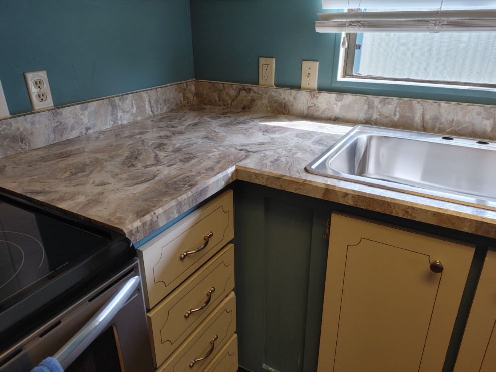Kitchen - mid-sized kitchen idea with white cabinets, laminate countertops, an island and beige countertops