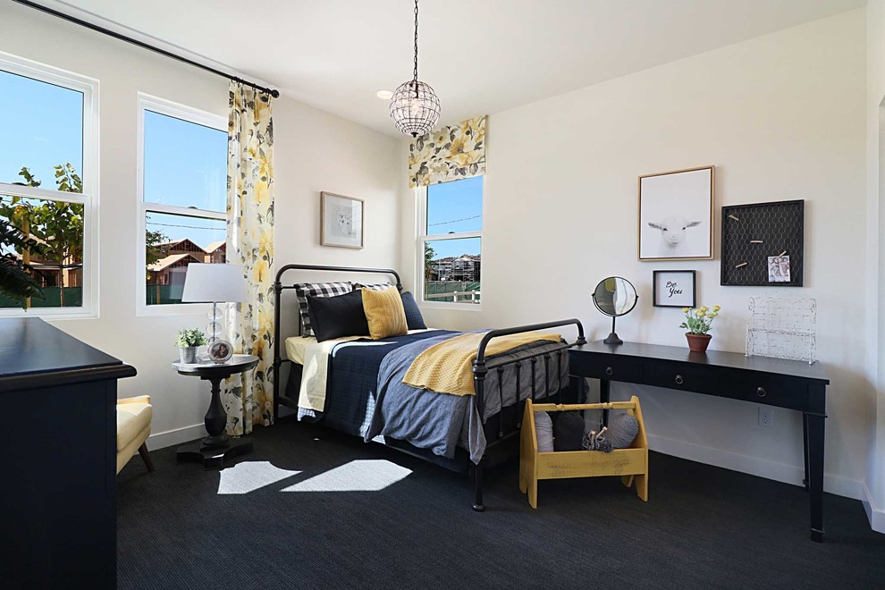 This is an example of a country kids' room for girls in Los Angeles with beige walls, carpet and black floor.