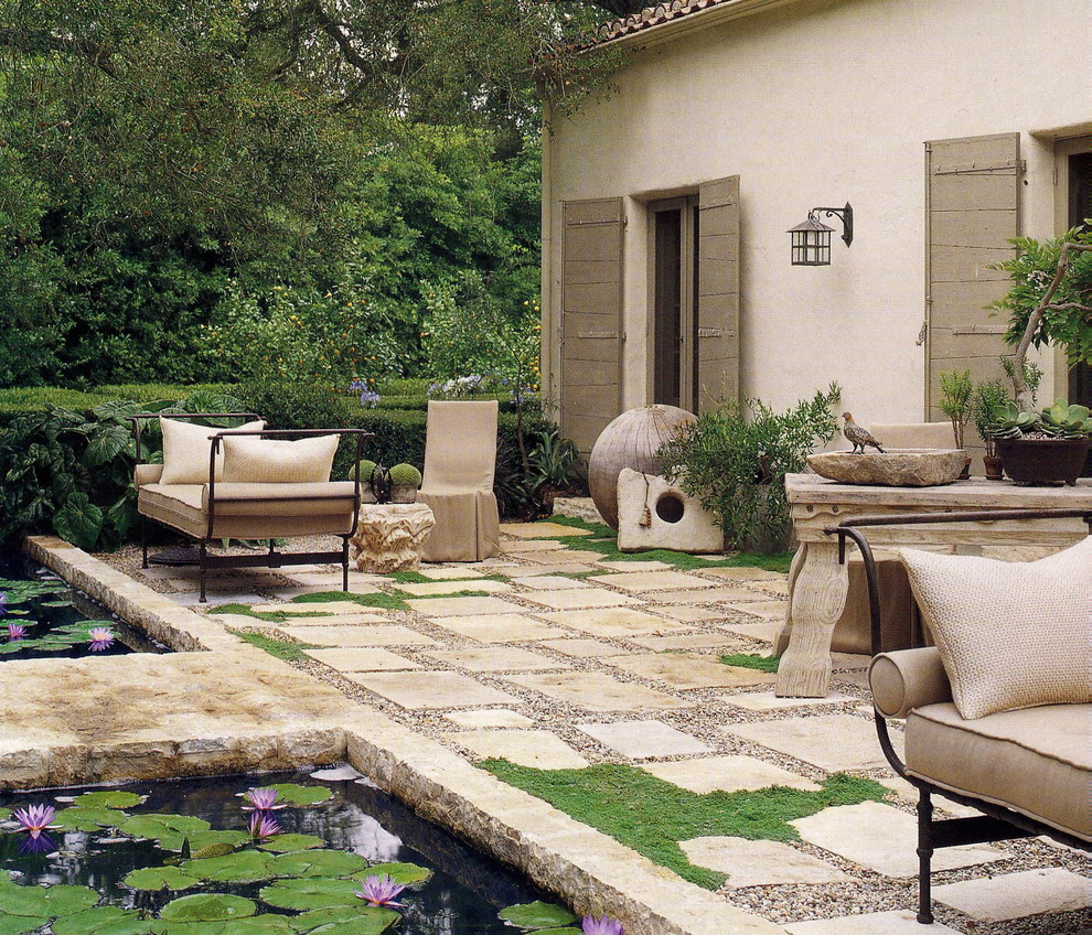 Mediterranean patio in New York with a water feature.