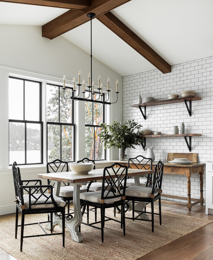 Country dining room in Seattle with white walls, light hardwood floors and no fireplace.