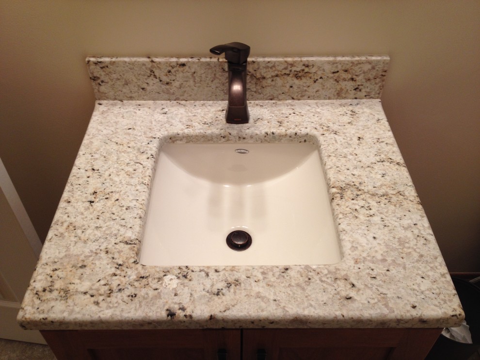 Home design - small transitional beige tile home design idea with an undermount sink, shaker cabinets, medium tone wood cabinets, granite countertops and beige walls