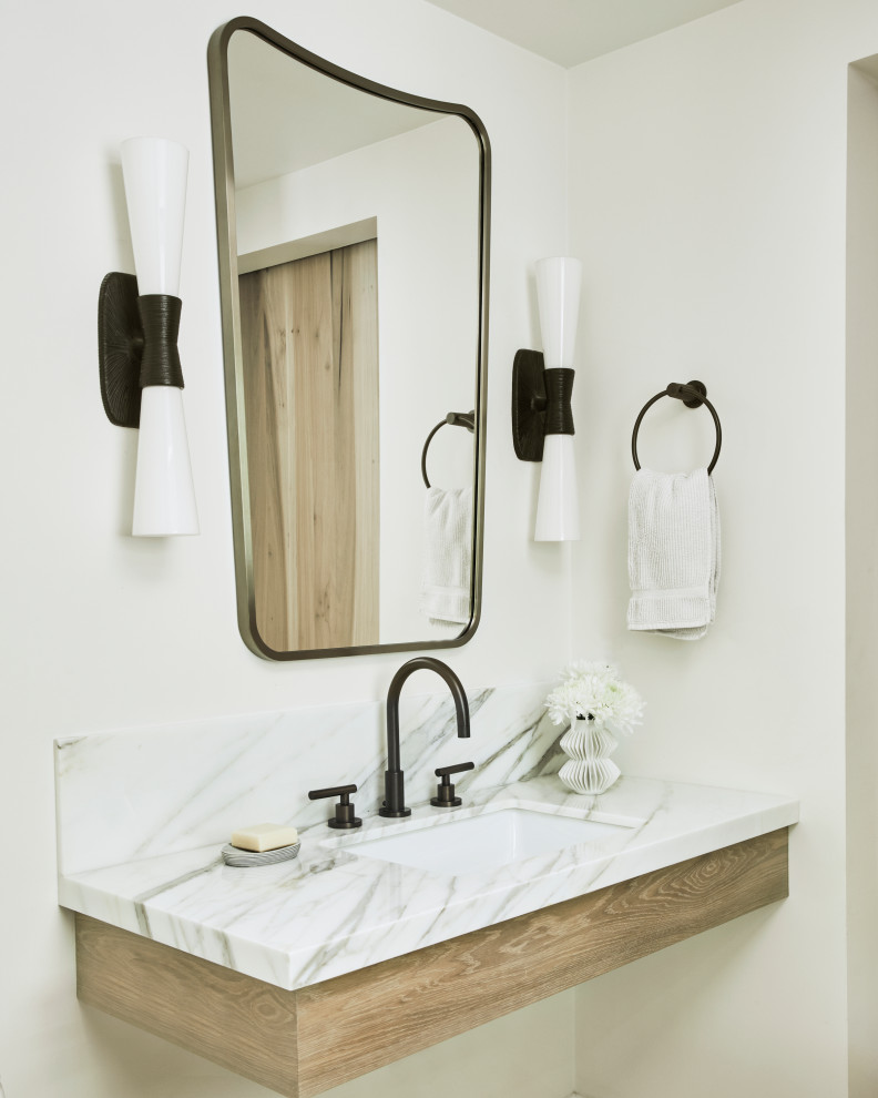 Medium sized traditional bathroom in Los Angeles with light wood cabinets, a single sink and a floating vanity unit.