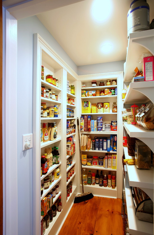 Mid-sized traditional u-shaped kitchen pantry with open cabinets, white cabinets and medium hardwood floors.