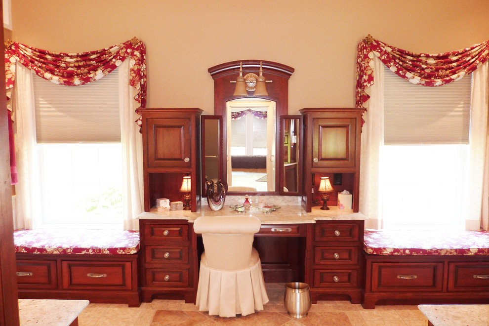 Traditional master bathroom in Cincinnati with raised-panel cabinets, medium wood cabinets, marble benchtops, beige tile, porcelain tile and porcelain floors.