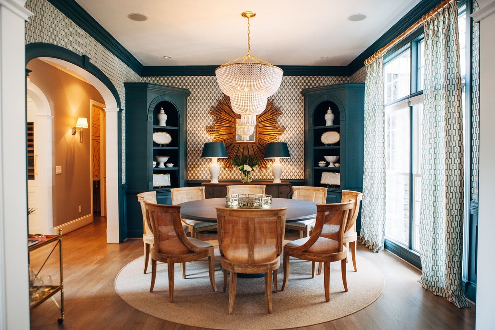 This is an example of a traditional dining room in Charlotte with white walls, medium hardwood floors and brown floor.