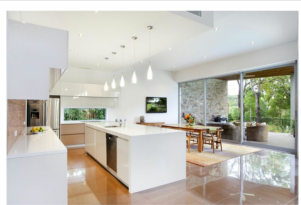 Large contemporary eat-in kitchen in Sunshine Coast with an undermount sink, recessed-panel cabinets, white cabinets, quartz benchtops, glass sheet splashback, stainless steel appliances, ceramic floors and with island.