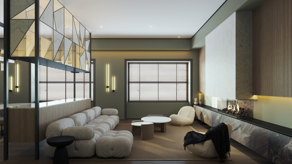 Immagine di un soggiorno minimalista di medie dimensioni e aperto con pareti verdi, parquet chiaro, camino sospeso, cornice del camino in cemento e nessuna TV