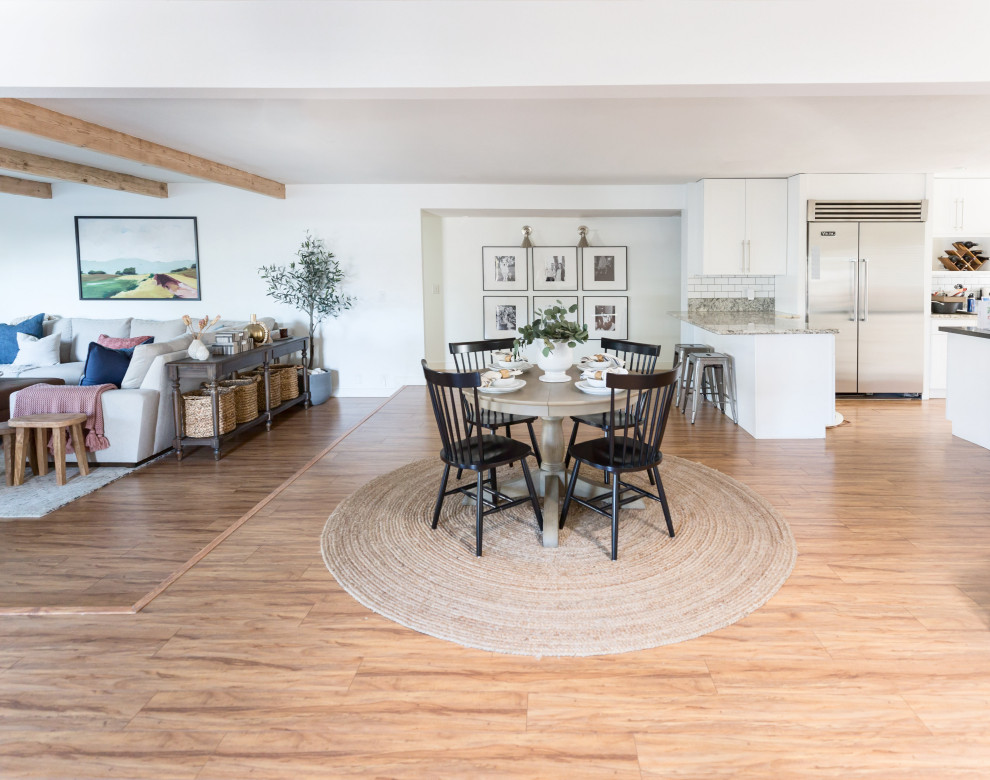 Inspiration for a mid-sized country open plan dining in Phoenix with laminate floors and beige floor.