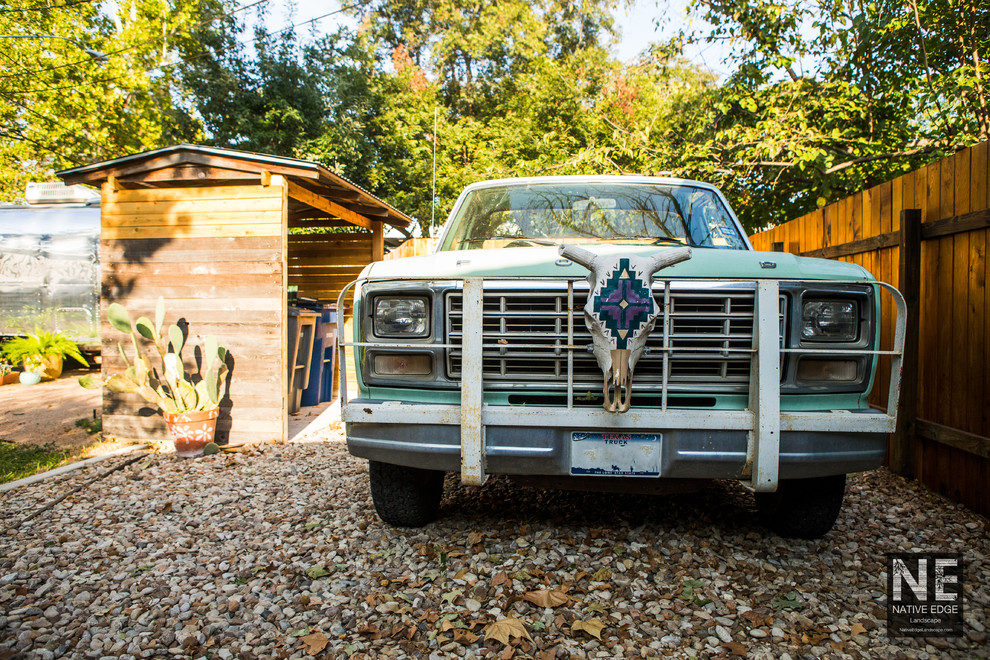 This is an example of a mid-sized rustic backyard concrete paver driveway in Austin.