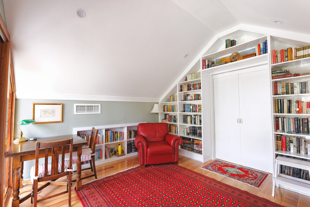 This is an example of a small traditional study room in Perth with light hardwood floors and a freestanding desk.