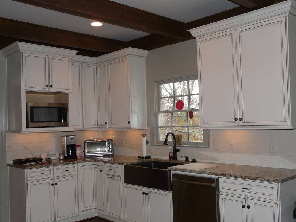 Transitional eat-in kitchen photo in Birmingham with a farmhouse sink, flat-panel cabinets, granite countertops, porcelain backsplash and stainless steel appliances