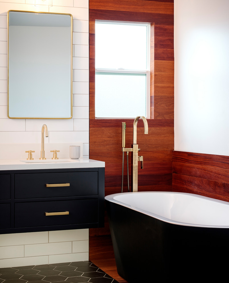 Inspiration for a mid-sized contemporary master bathroom in San Diego with flat-panel cabinets, black cabinets, a freestanding tub, an open shower, a one-piece toilet, white tile, porcelain tile, white walls, cement tiles, an undermount sink, engineered quartz benchtops, black floor, an open shower and white benchtops.