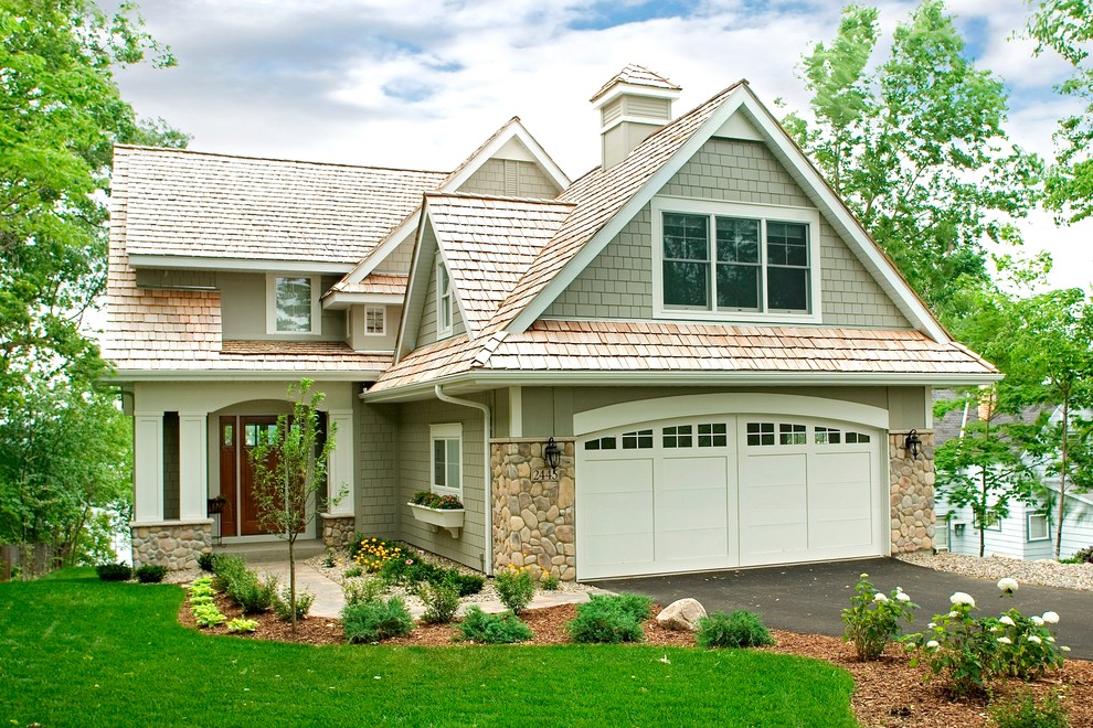 Design ideas for an arts and crafts split-level beige exterior in Other with stone veneer.