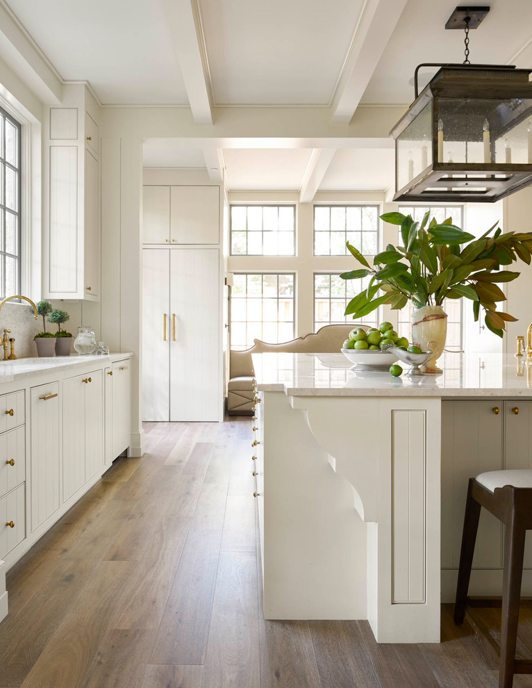 Large transitional u-shaped medium tone wood floor eat-in kitchen photo in Dallas with an undermount sink, flat-panel cabinets, white cabinets, quartz countertops, multicolored backsplash, mosaic tile backsplash, paneled appliances and an island