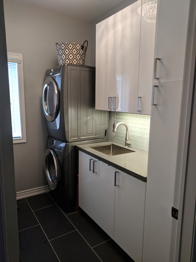 This is an example of a mid-sized contemporary laundry room in Other with flat-panel cabinets, white cabinets, purple walls, ceramic floors and grey floor.