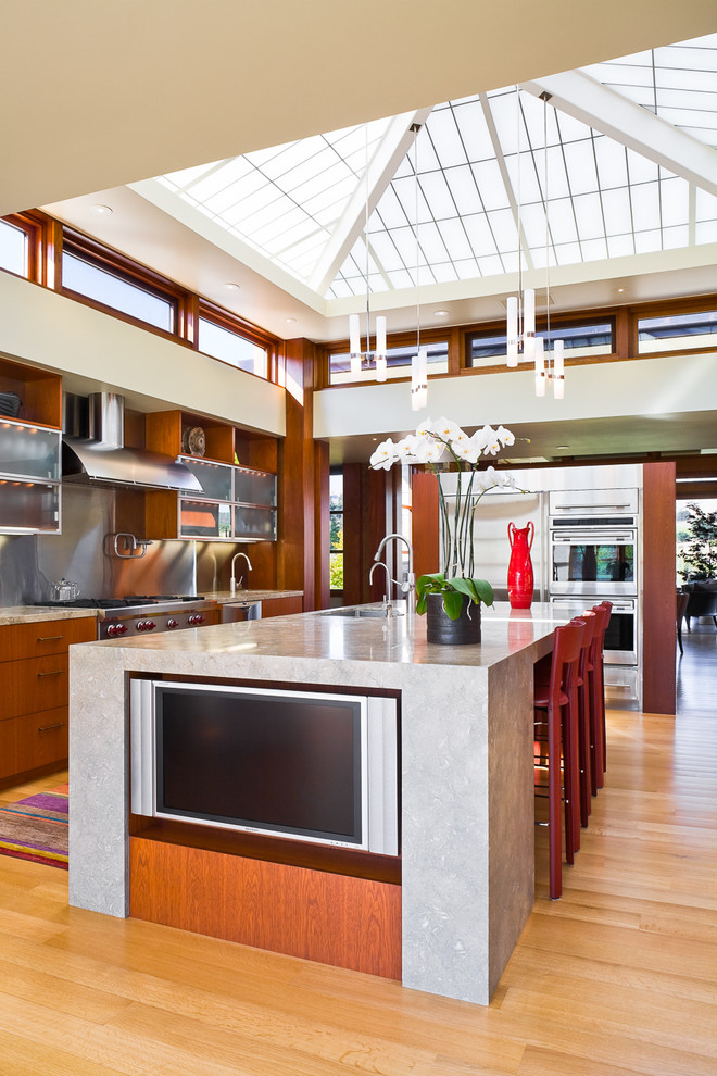 Photo of a contemporary kitchen in San Luis Obispo with flat-panel cabinets, medium wood cabinets, metallic splashback and stainless steel appliances.