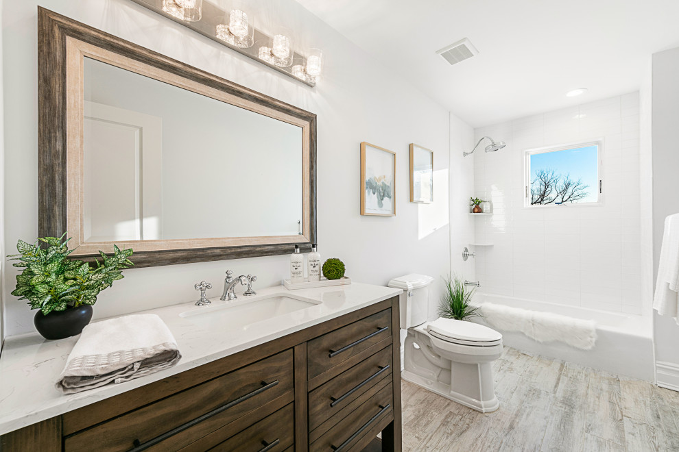 This is an example of a large transitional 3/4 bathroom in New York with flat-panel cabinets, medium wood cabinets, an alcove shower, a two-piece toilet, white tile, porcelain tile, white walls, an undermount sink, beige floor, white benchtops, a single vanity and a built-in vanity.