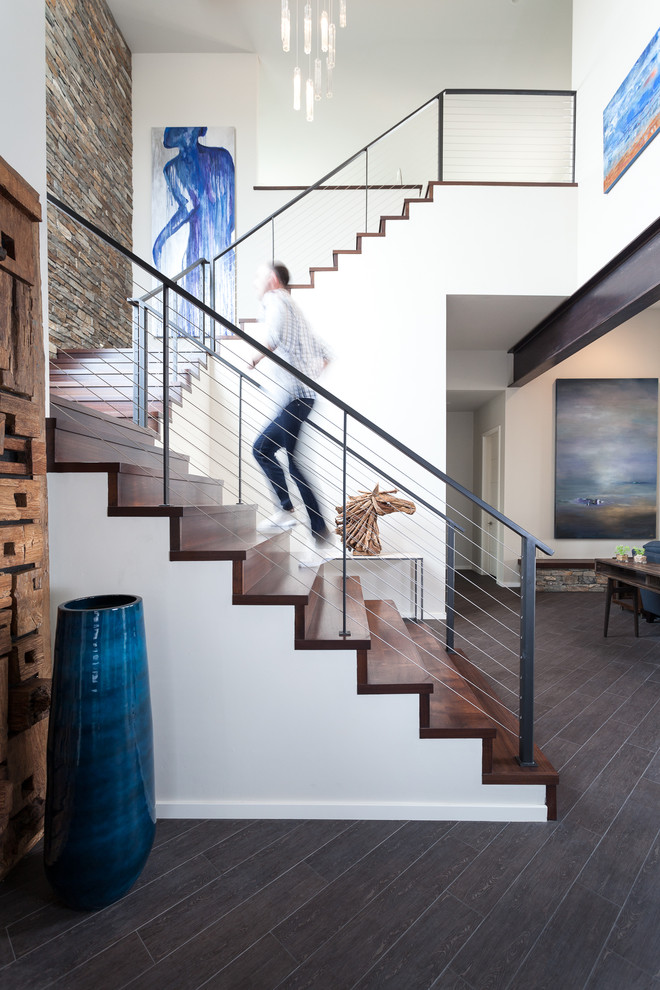 Photo of a transitional wood staircase in Sacramento with wood risers and cable railing.