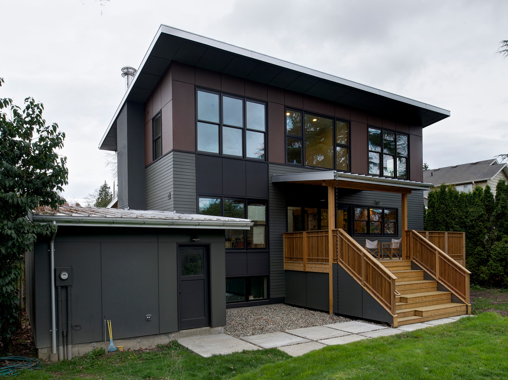This is an example of a mid-sized contemporary two-storey exterior in Seattle with concrete fiberboard siding.