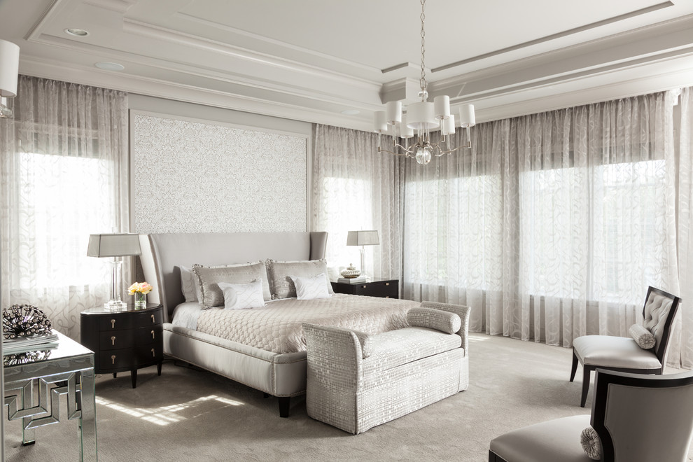 Inspiration for a large transitional master bedroom in Miami with grey walls and carpet.
