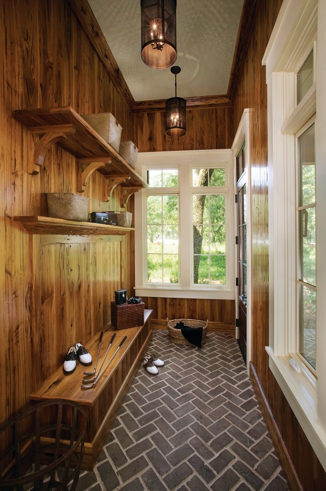Inspiration for a mid-sized traditional mudroom in Atlanta with brown walls, brick floors and a single front door.