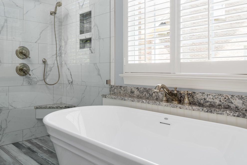 Mid-sized transitional master black and white tile and porcelain tile porcelain tile and gray floor freestanding bathtub photo with shaker cabinets, white cabinets, a two-piece toilet, gray walls, an undermount sink, granite countertops, a hinged shower door and gray countertops