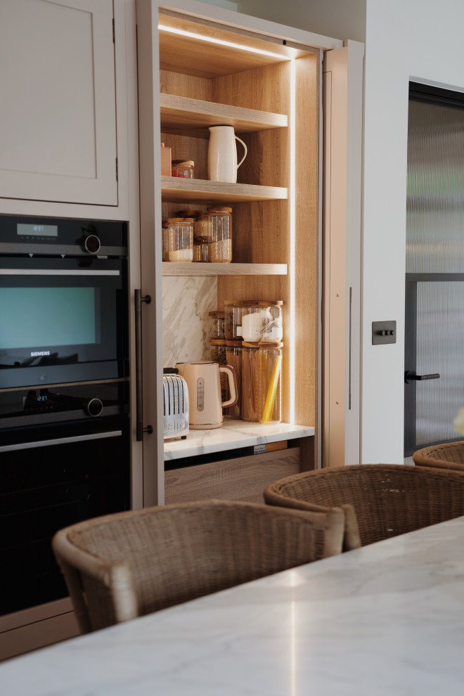 Photo of a medium sized classic l-shaped kitchen in London with a submerged sink, shaker cabinets, pink cabinets, quartz worktops, white splashback, an island and white worktops.