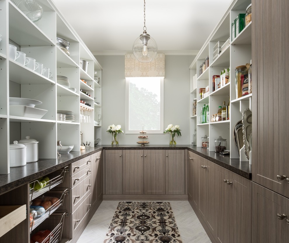 Inspiration for a mid-sized country u-shaped kitchen pantry in Chicago with grey floor, flat-panel cabinets, medium wood cabinets, solid surface benchtops, porcelain floors and no island.