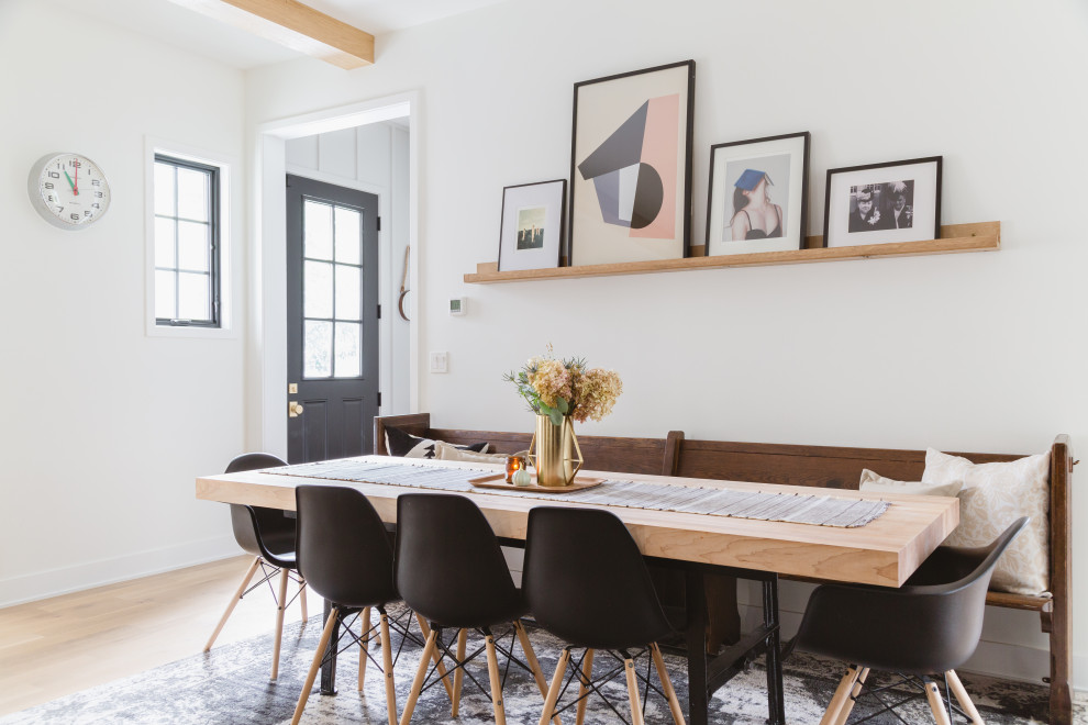 Small scandinavian dining room in Chicago with white walls, light hardwood floors and no fireplace.