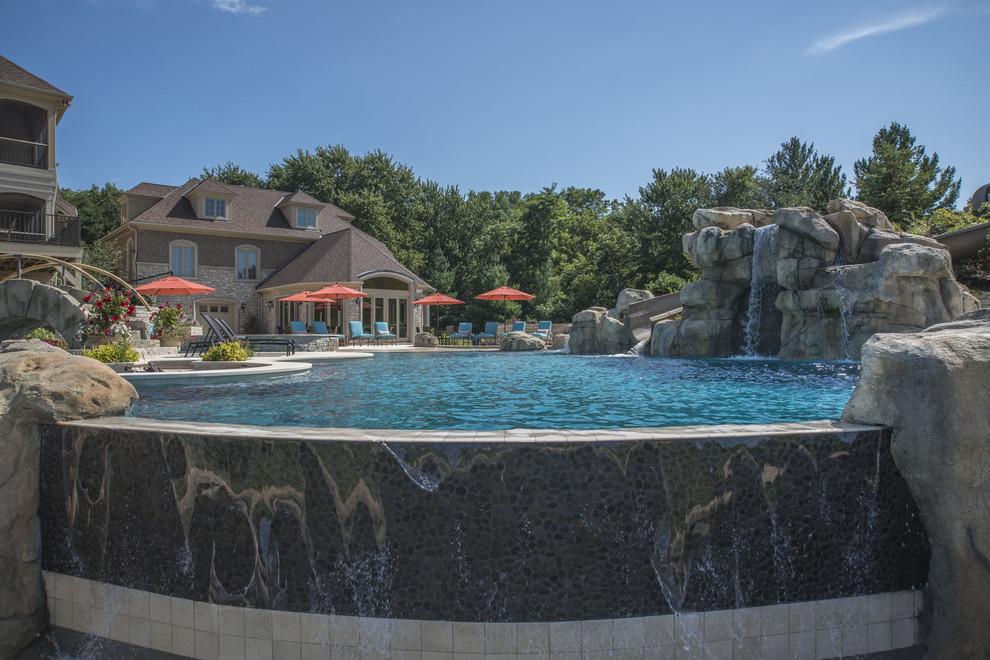 Inspiration for a huge backyard stone and custom-shaped infinity pool fountain remodel in Chicago