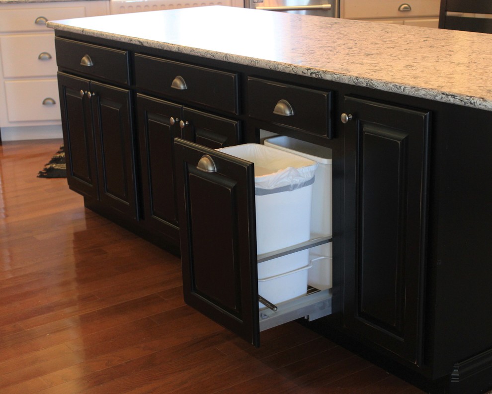 Large mountain style l-shaped light wood floor open concept kitchen photo in Chicago with a farmhouse sink, raised-panel cabinets, white cabinets, quartz countertops, stainless steel appliances and an island