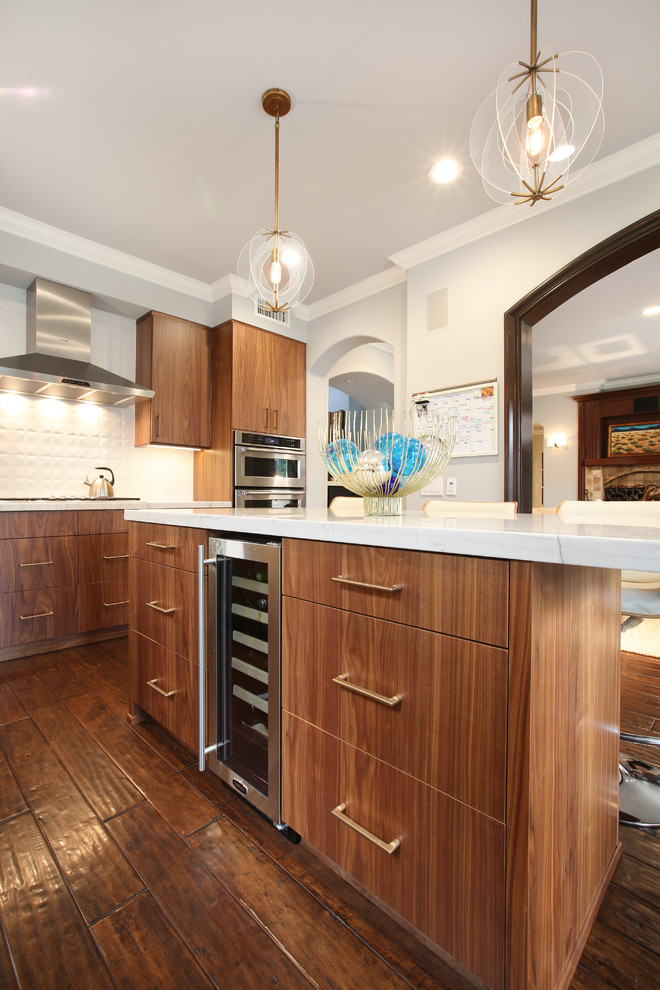 Inspiration for a l-shaped medium tone wood floor kitchen remodel in Orange County with an undermount sink, flat-panel cabinets, medium tone wood cabinets, quartzite countertops, white backsplash, stainless steel appliances and an island