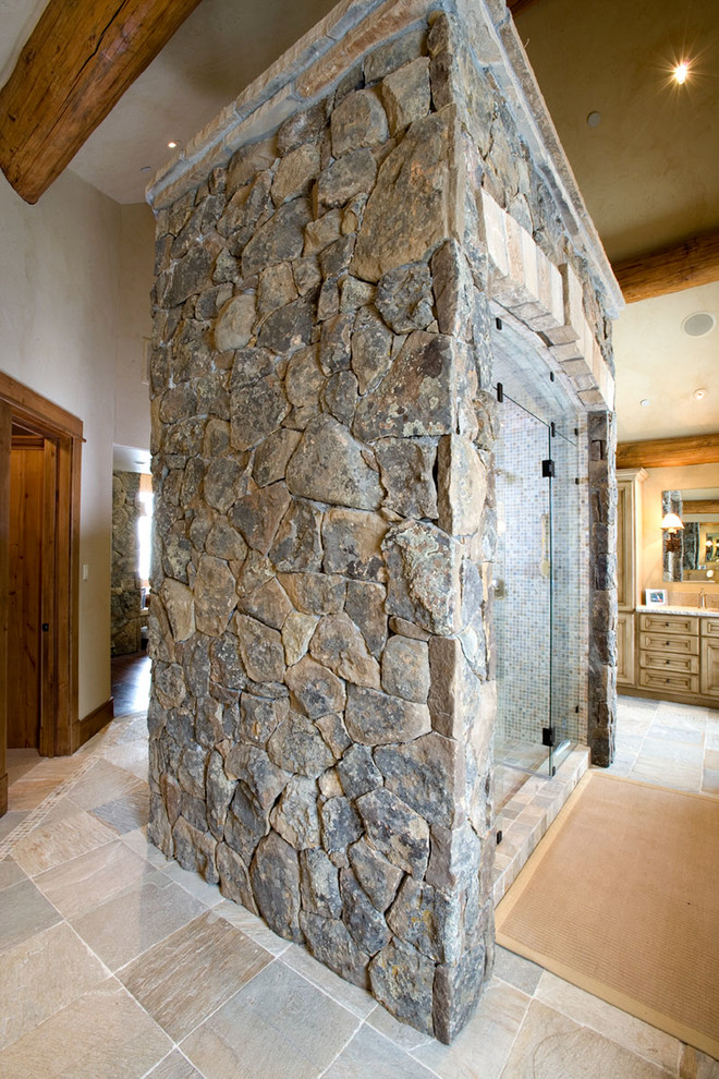 Inspiration for a rustic master beige tile ceramic tile doorless shower remodel with recessed-panel cabinets and light wood cabinets