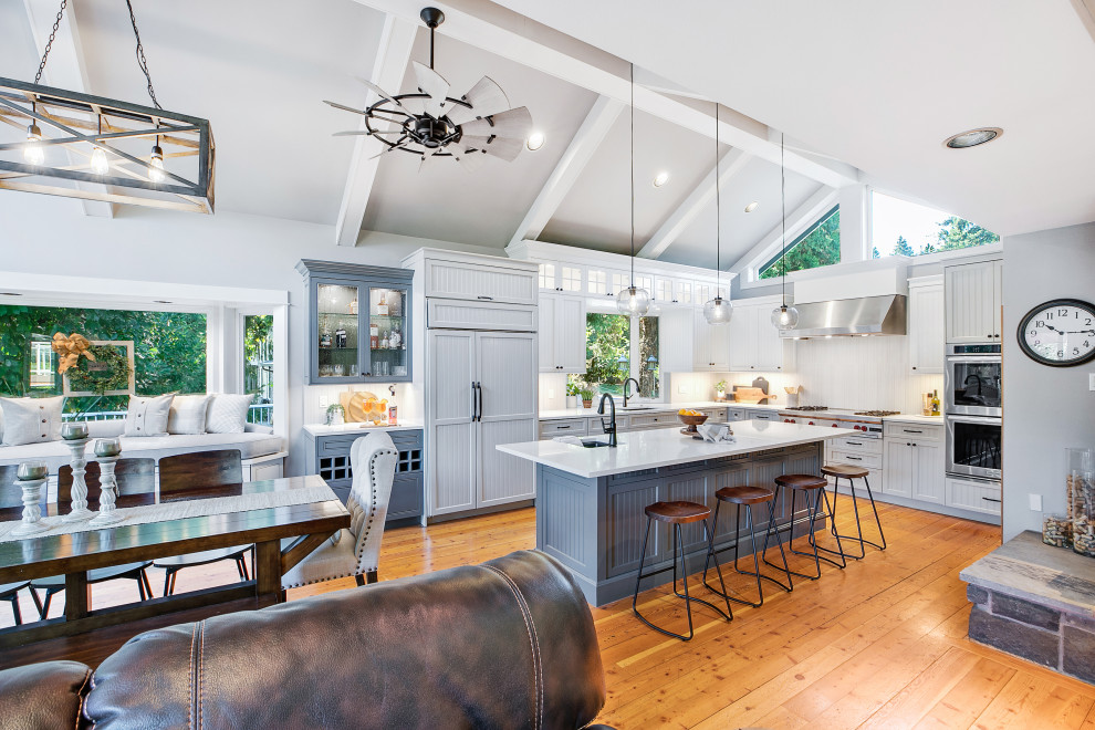 Inspiration for a large u-shaped eat-in kitchen in Portland with an undermount sink, beaded inset cabinets, grey cabinets, quartz benchtops, grey splashback, porcelain splashback, stainless steel appliances, medium hardwood floors, with island, brown floor, white benchtop and vaulted.