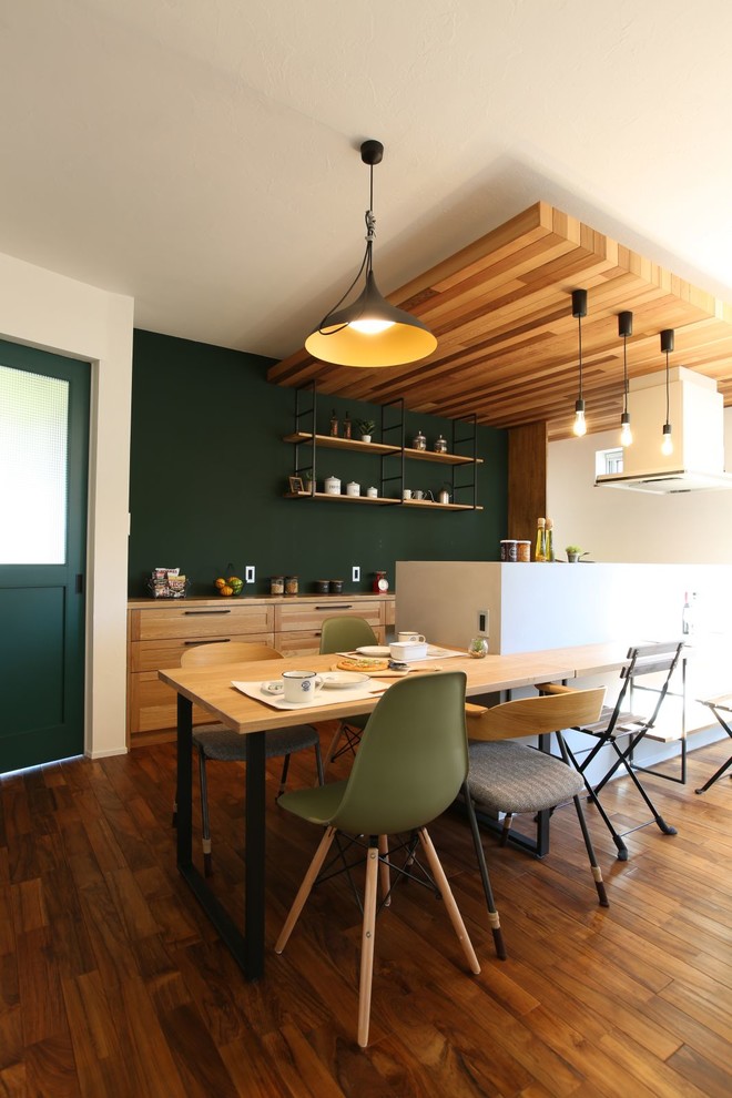Design ideas for an asian kitchen/dining combo in Other with green walls, medium hardwood floors and brown floor.