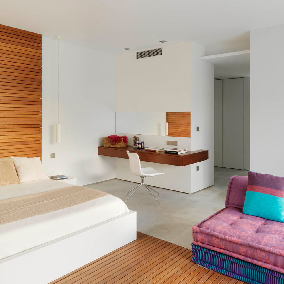 Example of a mid-sized trendy master concrete floor bedroom design in Other with white walls