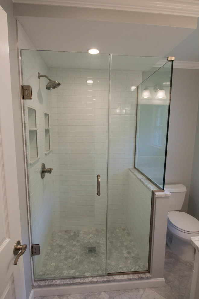 Small transitional master white tile and ceramic tile marble floor and gray floor corner shower photo in Newark with shaker cabinets, white cabinets, a two-piece toilet, gray walls, an undermount sink, marble countertops and a hinged shower door