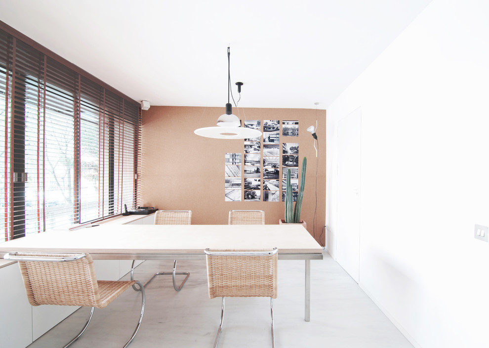 Mid-sized contemporary study room in Barcelona with white walls, concrete floors, no fireplace and a built-in desk.
