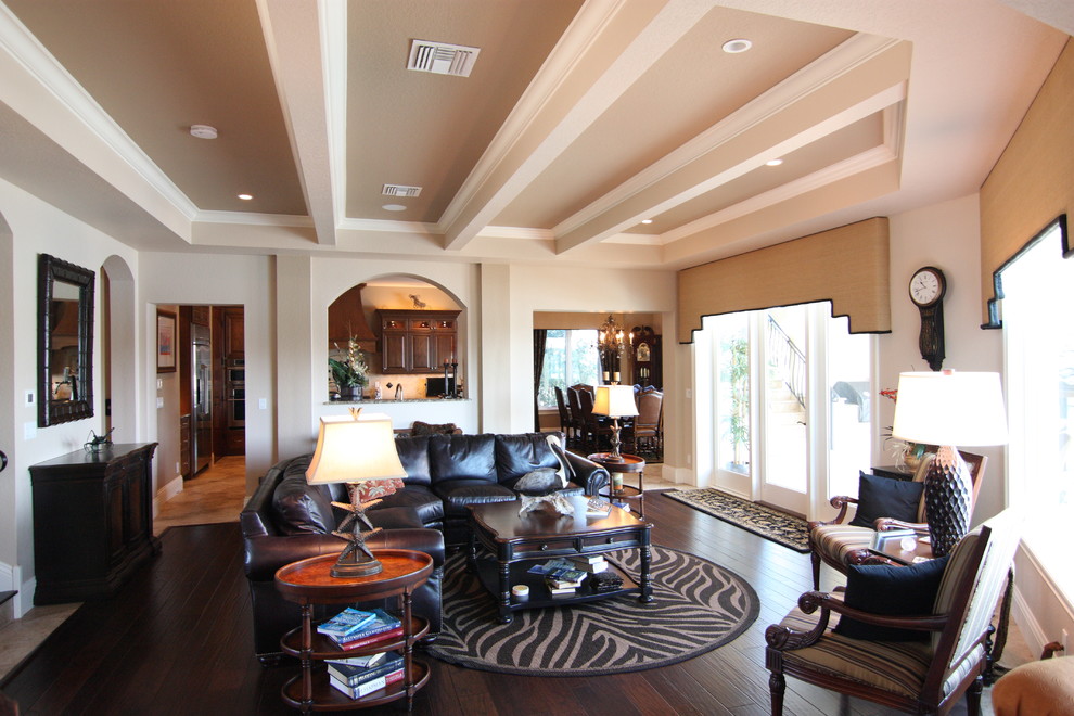 This is an example of a mid-sized mediterranean open concept living room in Orlando with beige walls.
