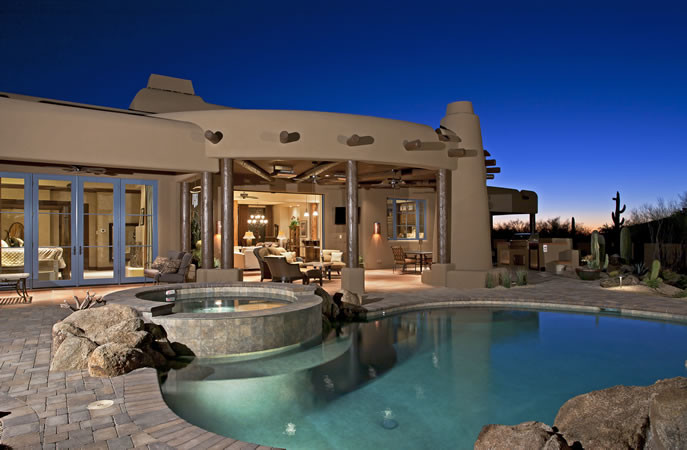 Inspiration for a mid-sized backyard round lap pool in Phoenix with a hot tub and brick pavers.