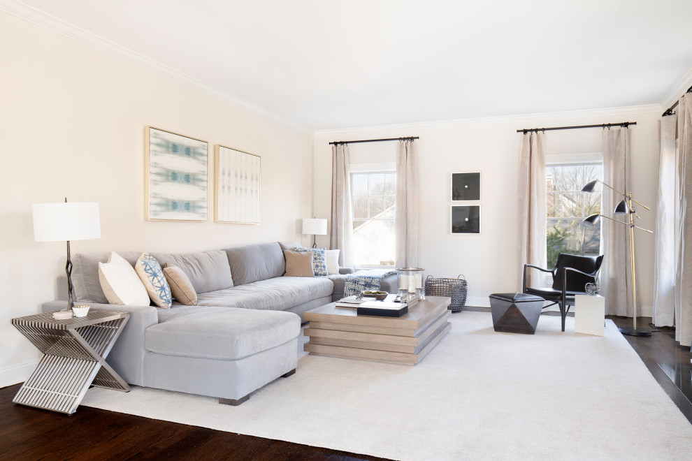 This is an example of a transitional living room in New York with beige walls, dark hardwood floors, no fireplace and no tv.